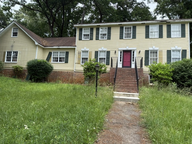 Two-story home with a red front door